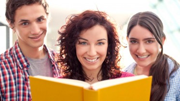 Students-Reading-At-The-Library-Books-Smiling-Friends